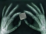 Skeletal Hands Holding Barcode