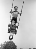 1930s Two Boys Sitting Standing On Playground Swing