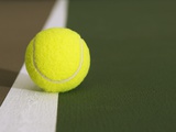 Tennis ball on white boundary stripe