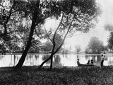1890s 1900 Older Brother Watching Three Younger Children In Rowboat On Small Lake