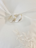 Close up of wedding rings on pillow
