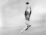 1970s Player Jumping To Catch Football Pass
