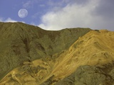Full moon setting over mountain in Kluane National Park