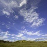 Lofty cumulus and cirrus clouds over sagebrush prairie