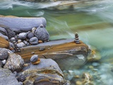 Small stone cairn on striated boulder in the Verzasca River