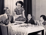 Mother serving a turkey on a platter