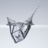 Ice cube splashing in water