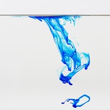 Blue dye floating in water