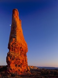 Moon and sandstone spire at Arches National Park