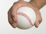 Close up of pitcher holding baseball