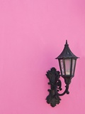 Street lamp on pink wall of Colonial style building