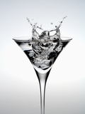 Wineglass of splashing water