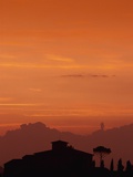 Farmhouse Silhouetted at Sunset