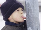 Boy Putting Tongue to Frozen Pole
