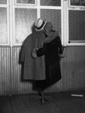 Hanging Coats Posed as an Embracing Couple