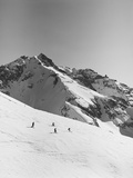 Skiers Skiing Down Mountain