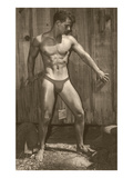 Muscle Man Posing by Wood Fence