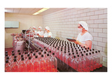 Masked Women Filling Bottles at Plant