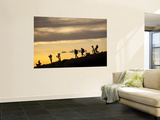 Young Man and Woman Hiking Through Desert at Sunset