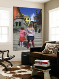 Two Girls on Ulica 1 Maja Street with Colourful Buildings
