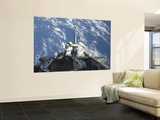 A Partial View of Space Shuttle Atlantis Backdropped by a Blue and White Earth
