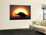 A Stegosaurus Silhouetted Against the Setting Sun at the End of a Prehistoric Day