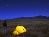 Hiker and Tent Illuminated Under the Night Sky  Great Sand Dunes National Park  Colorado  USA