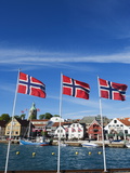 Norwegian Flags and Historic Harbour Warehouses  Stavanger  Norway  Scandinavia  Europe