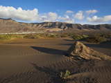 Volcanic Cliffs Rising Over Desert Landscape Near Famara  with Bungalow Development  Canary Islands
