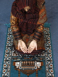 Muslim Woman Kneeling on Prayer Mat Saying Prayers  Jordan  Middle East