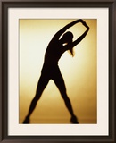Silhouette of a Woman Exercising