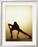 Silhouette of a Woman Exercising