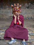 Young Buddhist Monk Holding Traditional Carved Wooden Mask to His Face at the Tamshing Phala Choepa