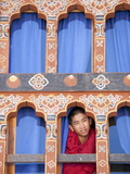 Young Buddhist Monk Looking Out of a Window at Trongsa Dzong  Trongsa  Bhutan  Asia
