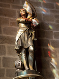Statue of St Joan of Arc with Coloured Light from Stained Glass  Church of Notre Dame  Vitre  Brit