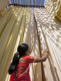 Woman in Sari Checking the Quality of Freshly Dyed Fabric Hanging to Dry  Sari Garment Factory  Raj