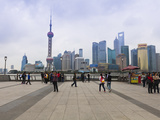 Pedestrians and Tourists on the Bund  the Futuristic Skyline of Pudong across the Huangpu River Bey