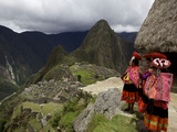 Traditionally Dressed Children Looking over the Ruins of Machu Picchu  UNESCO World Heritage Site  