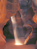 Sunbeam Illuminates Sandy Floor and Sandstone Walls of a Slot Canyon  Antelope Canyon  Page