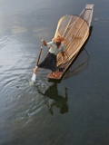 Intha Fisherman Rowing Boat with Fishing Net on Inle Lake  Myanmar  Asia