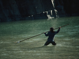 An Inuit Man Spears a Char for Friends During a Visit to their Camp