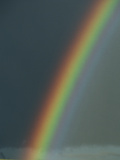 A Rainbow Arches across a Storm-Filled Sky