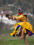 A Masked Dancer with Cymbals Performs Drametse Nga Cham (The Religious Masked Dance)
