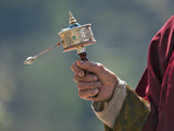 A Buddhist Spins His Hand-Held Prayer Wheel in a Clockwise Direction with the Help of a Weighted Ch