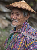 A Wizened Old Farmer Near Mongar Wears the Traditional Knee-Length National Robe Called Gho and a B
