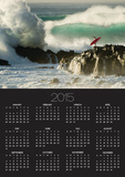 Surf Crashing near Surfer on Boulders