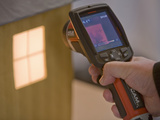 A Thermal Imaging Camera Being Used to Demonstrate Heat Loss from Building Windows