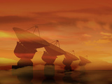 An Array of Radio Telescope Dishes at Sunset