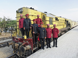Staff Members for the Palace on Wheels Train Posing with the Train  Udaipur  India