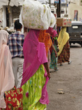 Colorful Indian Women in Traditional Saris Leaving Market in Udaipur with Containers on their Heads